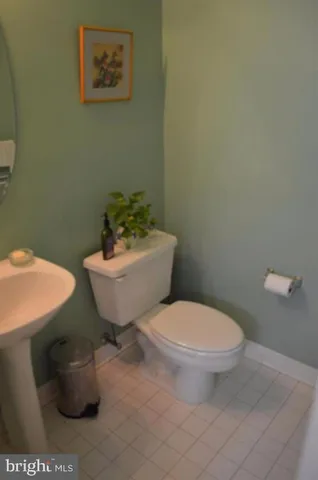 a white toilet sitting next to a bathroom sink