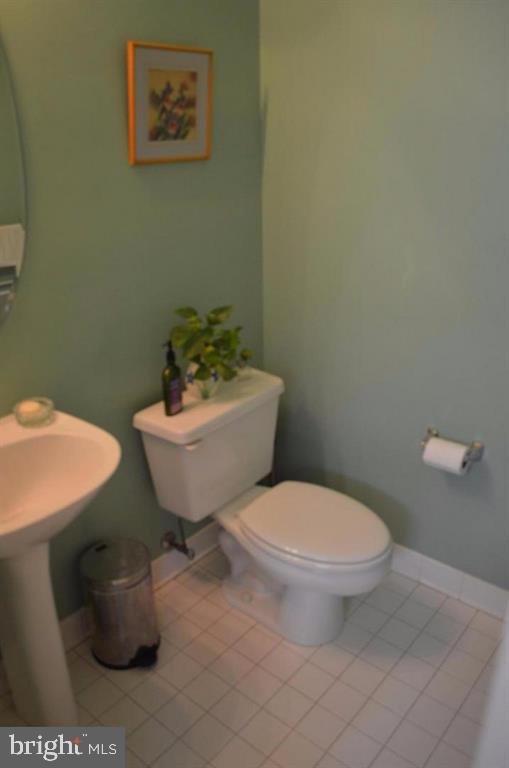 29 Stridesham Court Baltimore, MD 21209 - Photo 19 of 23 a white toilet sitting next to a bathroom sink