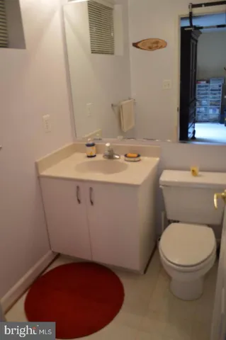 a bathroom with a toilet a sink and mirror