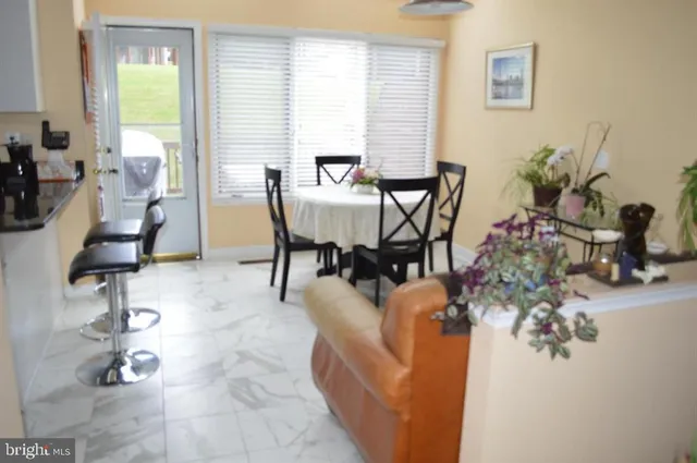 a dining room with furniture and wooden floor