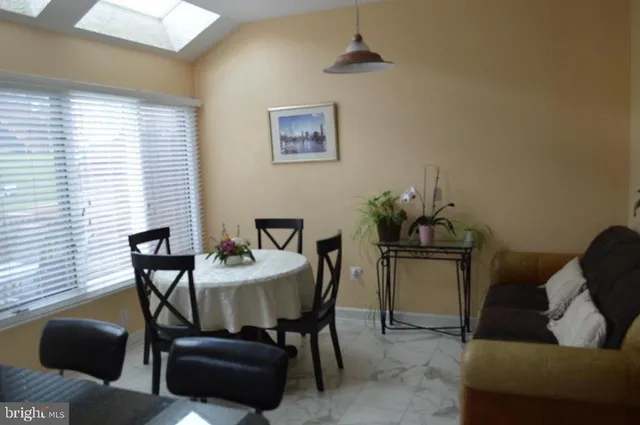 a dining room with furniture and window