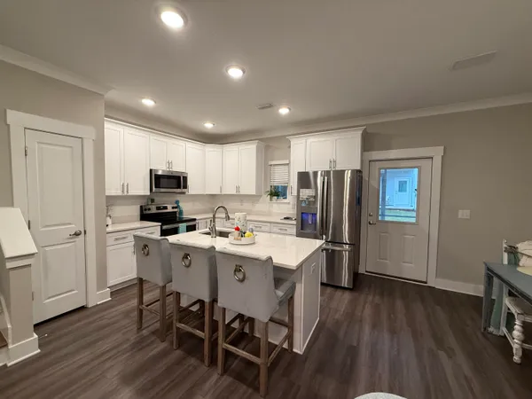 a dining room with furniture and wooden floor
