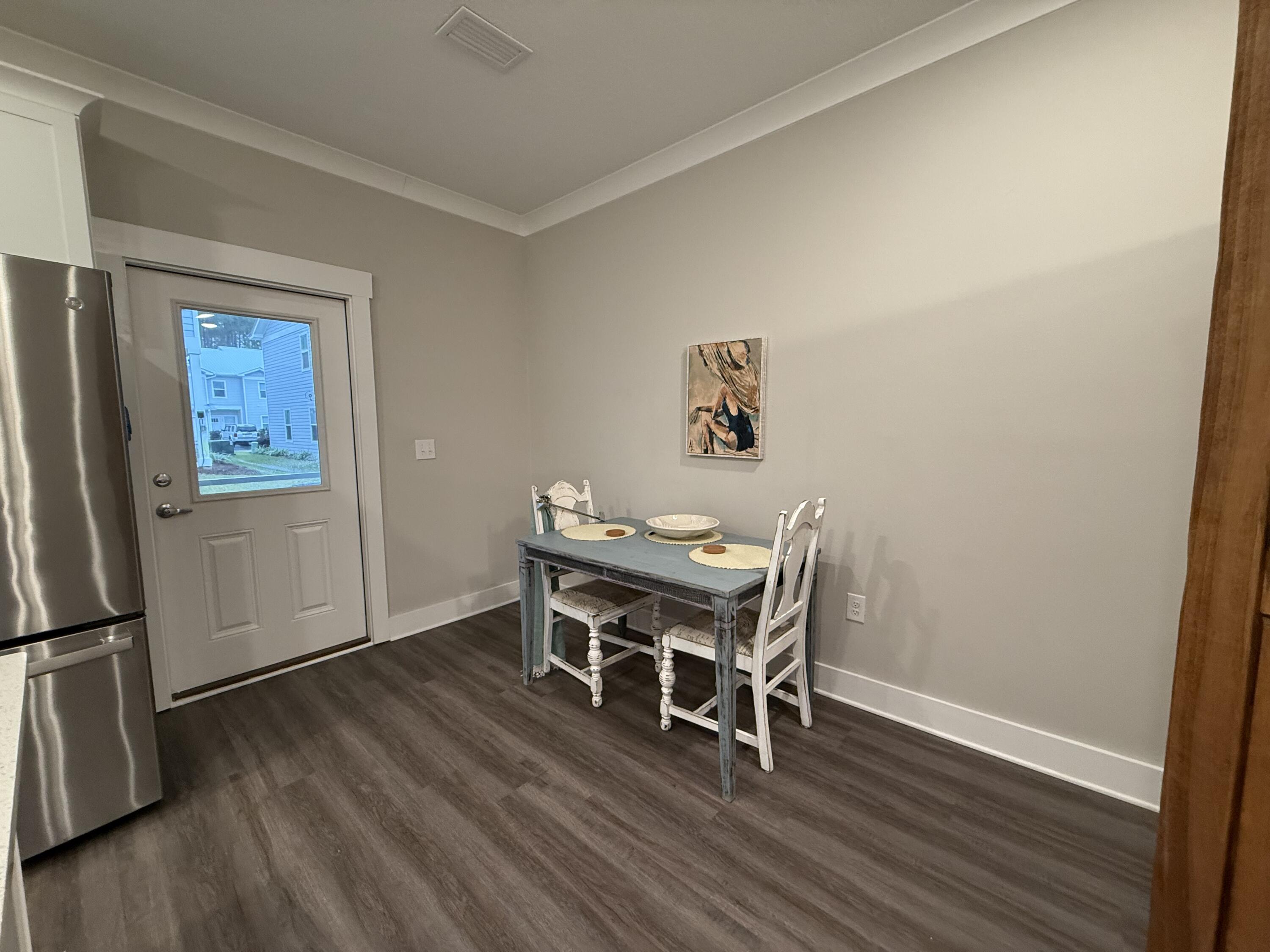 406 Date Palm Lane Freeport, FL 32439 - Photo 13 of 44 a dining room with furniture and wooden floor