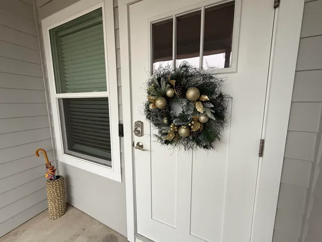 a view of a hallway with wooden floor and stairs