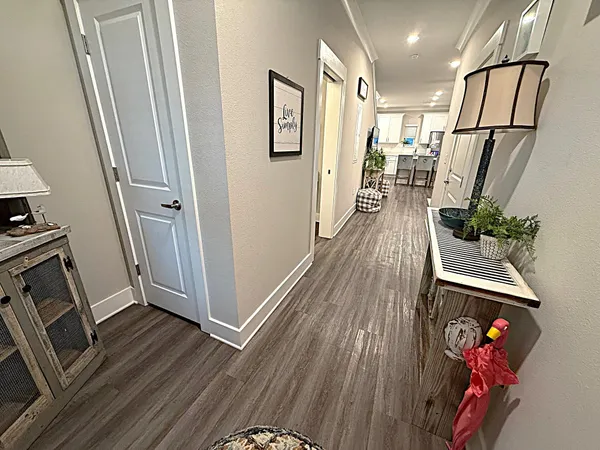 a kitchen with stainless steel appliances kitchen island a refrigerator and wooden floor