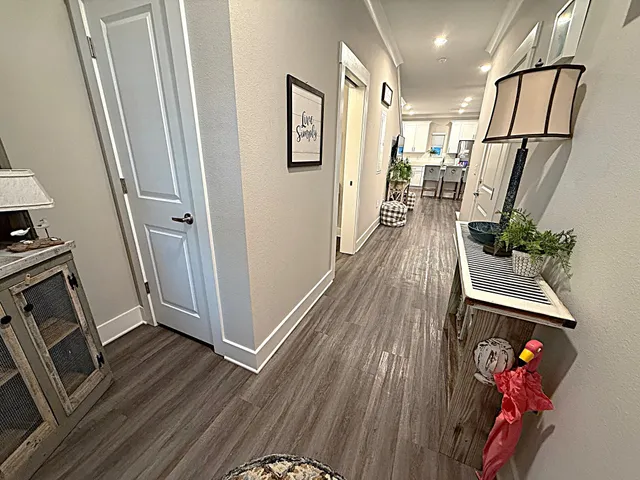 a kitchen with stainless steel appliances kitchen island a refrigerator and wooden floor