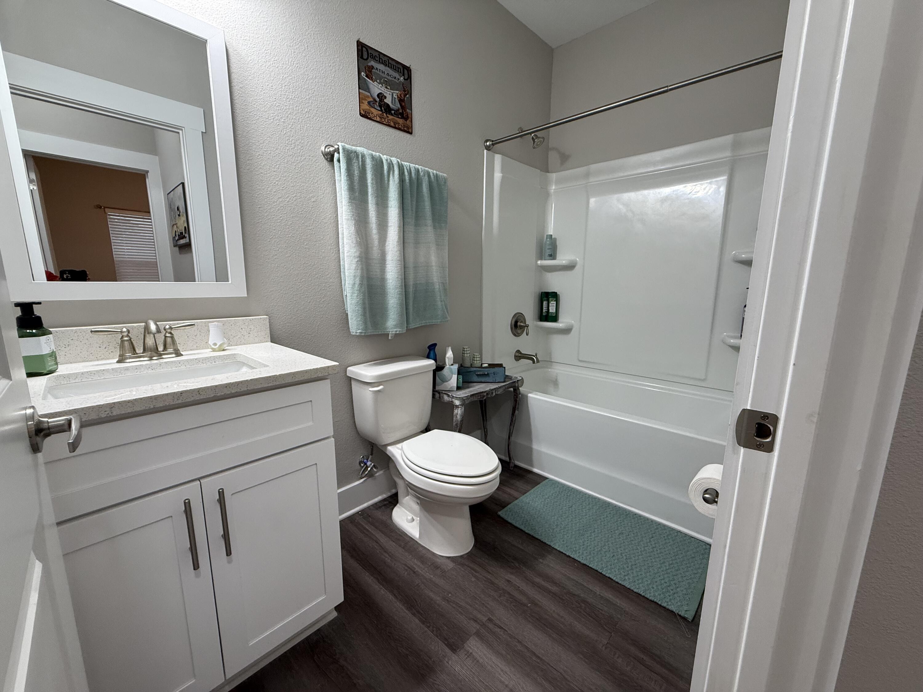 406 Date Palm Lane Freeport, FL 32439 - Photo 31 of 44 a bathroom with a toilet sink vanity tub and shower