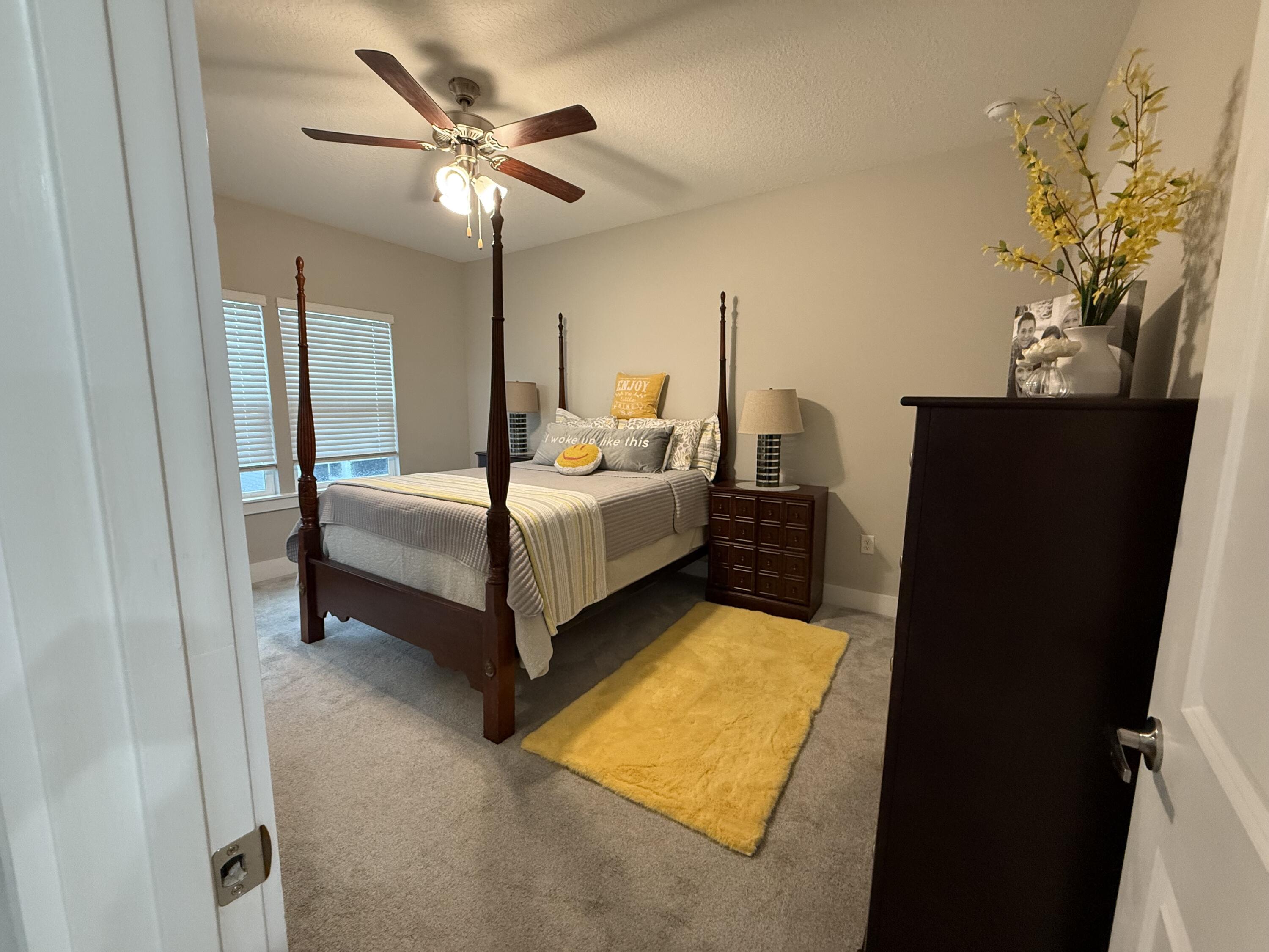 406 Date Palm Lane Freeport, FL 32439 - Photo 35 of 44 a bedroom with bed and a chandelier