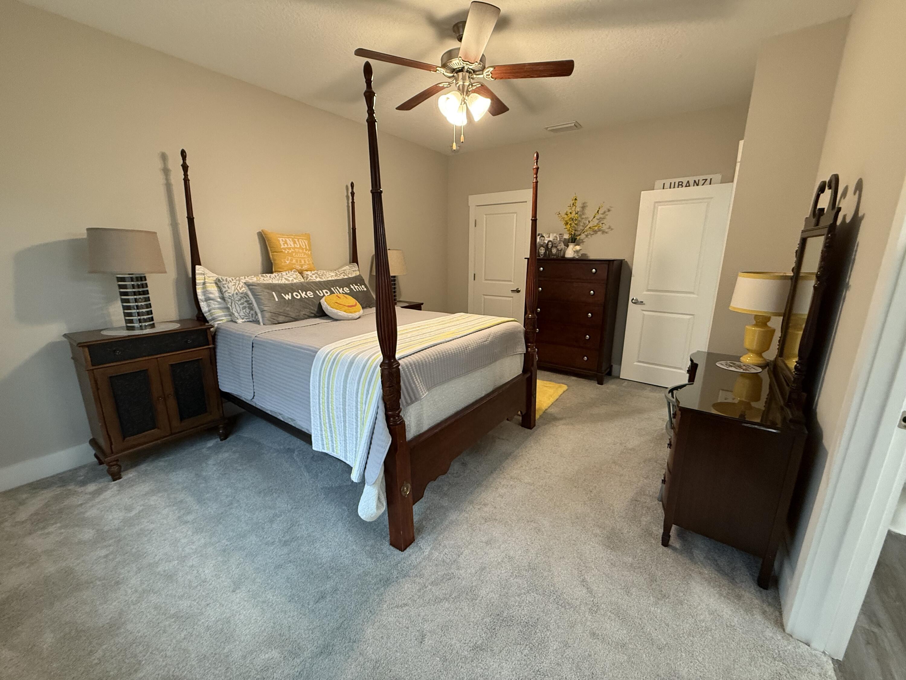 406 Date Palm Lane Freeport, FL 32439 - Photo 38 of 44 a bed room with a bed dresser and a flat screen tv