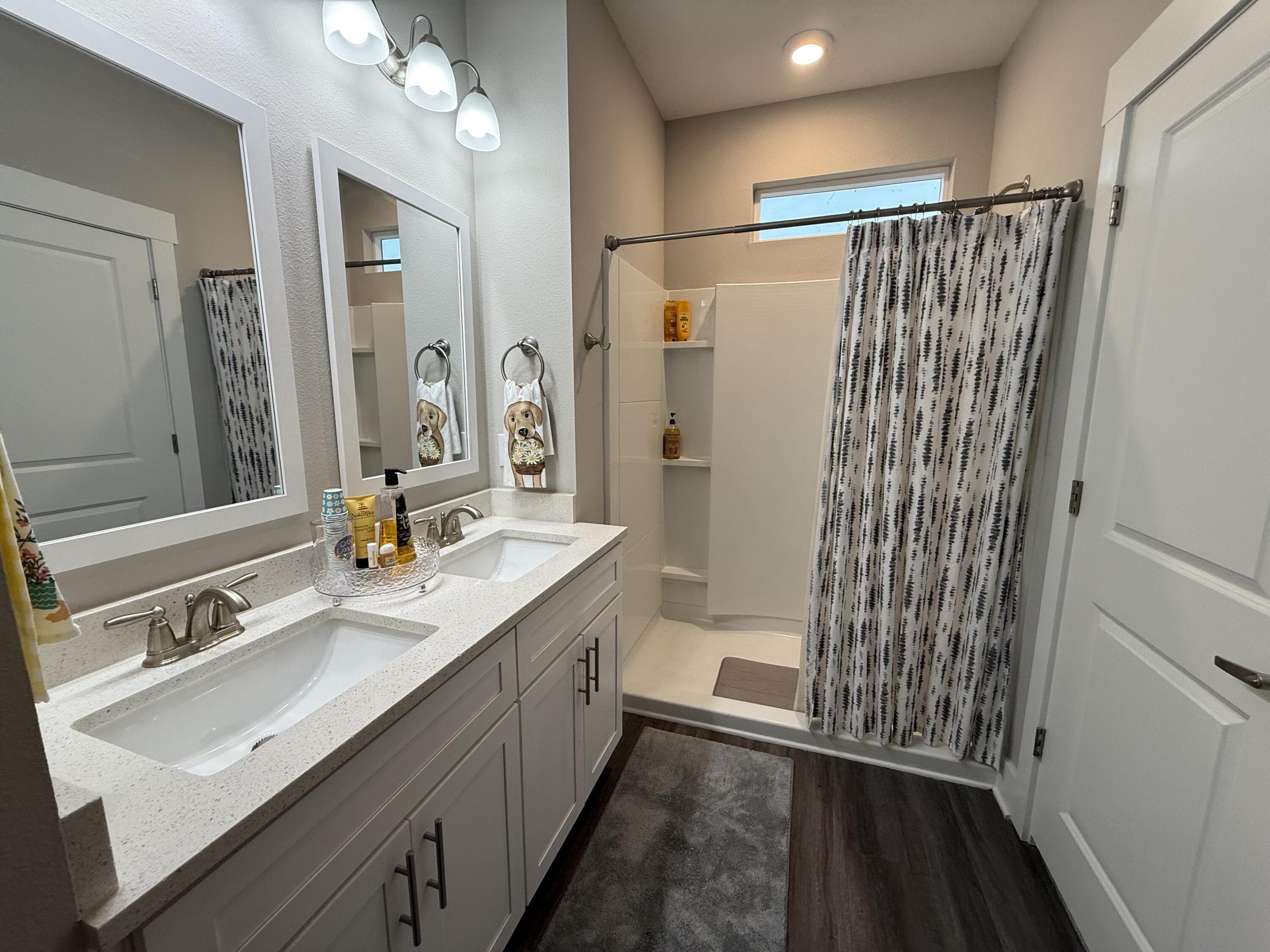 406 Date Palm Lane Freeport, FL 32439 - Photo 40 of 44 a bathroom with a double vanity sink mirror and shower