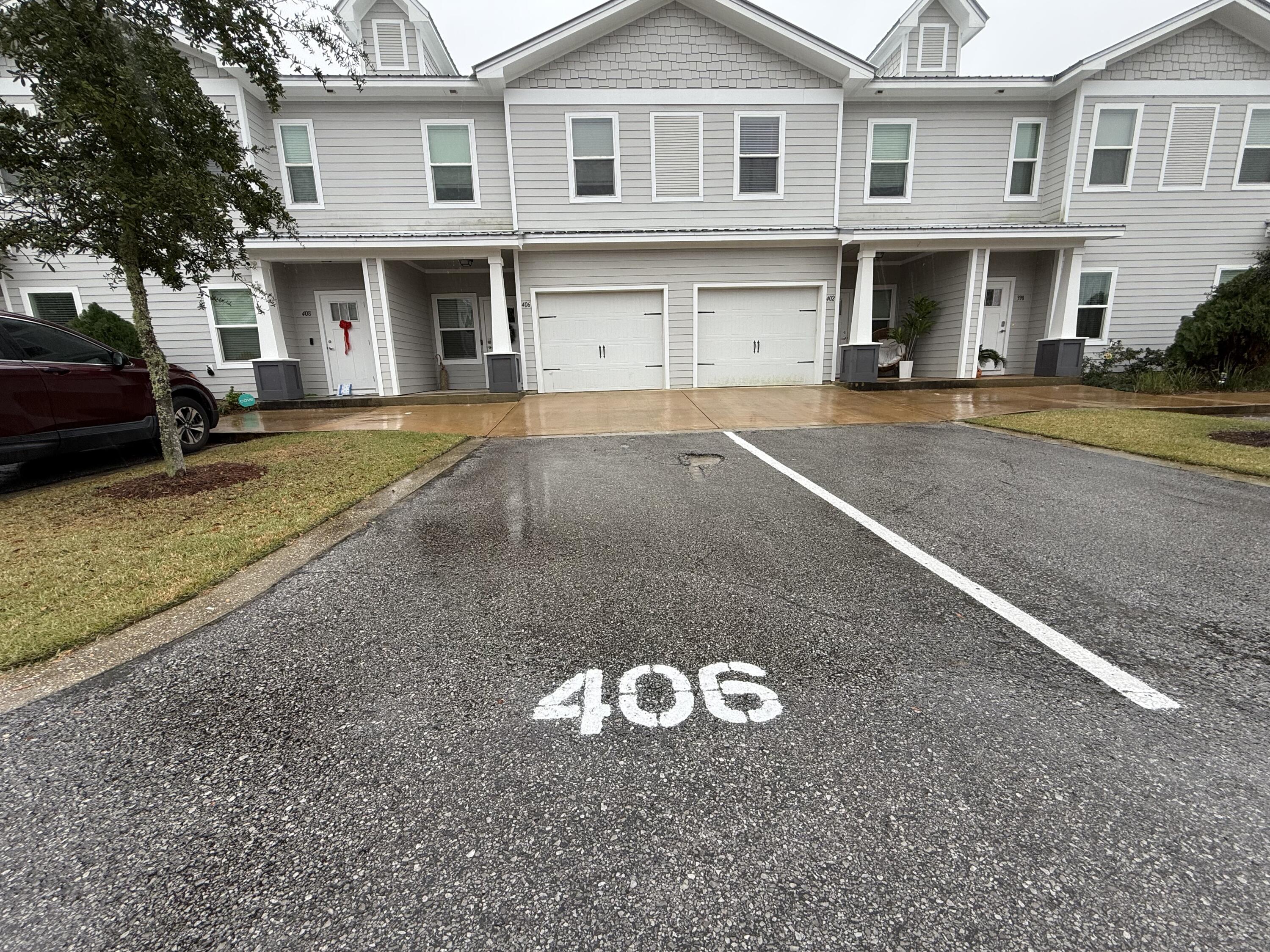 406 Date Palm Lane Freeport, FL 32439 - Photo 44 of 44 a view of a white house with large windows and a yard