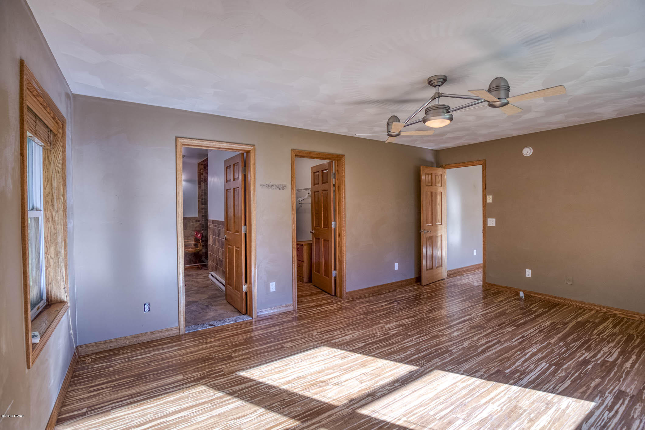424 Old Gravity Road Lake Ariel, PA 18436 - Photo 28 of 46 a view of an empty room with wooden floor and a window
