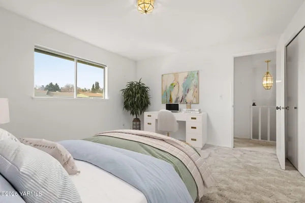 a bedroom with a large bed and a window