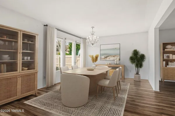 a dining room with furniture a rug and wooden floor