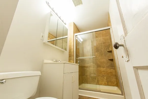 a bathroom with a shower and a sink