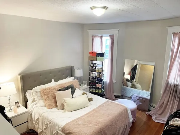 a bedroom with a bed and a mirror