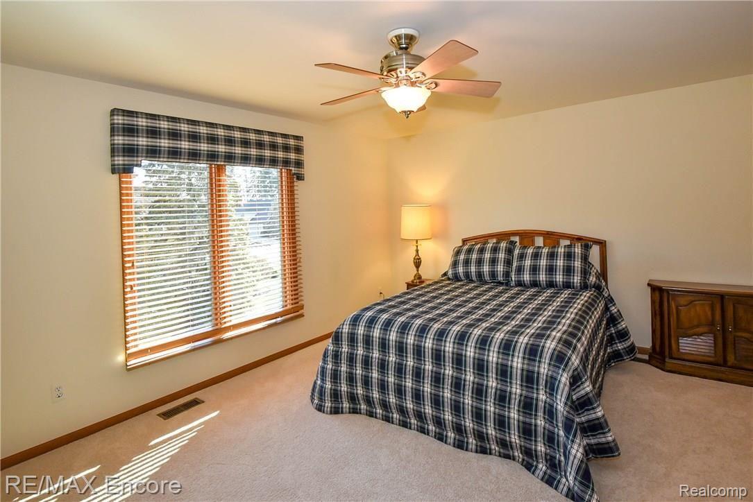 1284 Pebble Pointe Drive Rochester, MI 48307 - Photo 56 of 85 Bedroom 2 with newer carpeting and ceiling fan