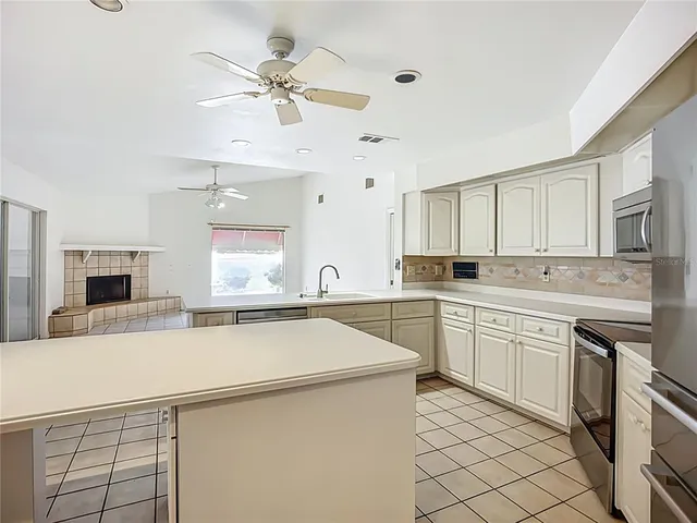 a kitchen with a sink appliances and cabinets