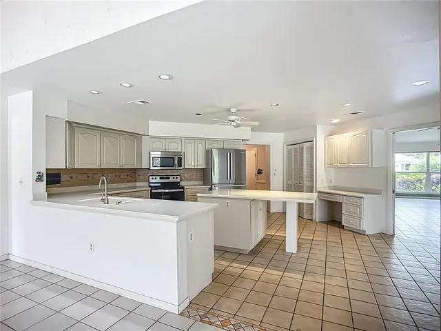 a kitchen with stainless steel appliances a sink and a refrigerator