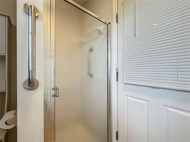 a view of a big room with a windows and chandelier