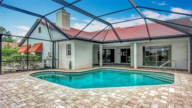 a view of a backyard with a swimming pool