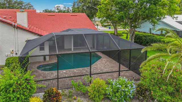 a view of a big house with a big yard and potted plants