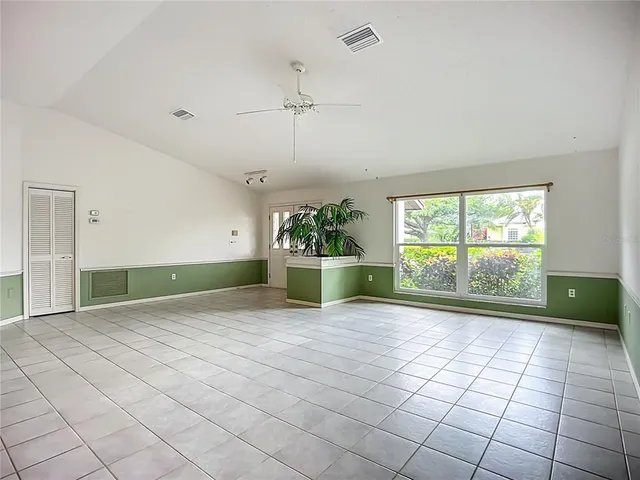 a view of a kitchen with an empty space and a window