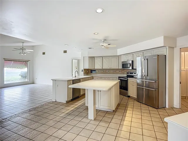 a kitchen with a sink cabinets and stainless steel appliances