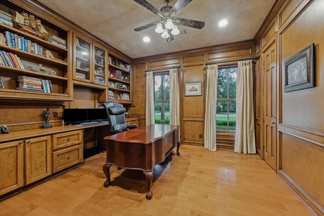 a living room with furniture a flat screen tv and a large window