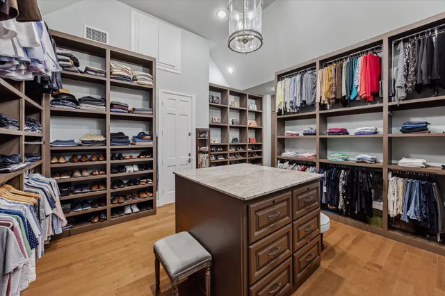 a kitchen with granite countertop a sink stove and cabinets