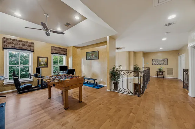 a view of a patio with chairs and floor to ceiling window