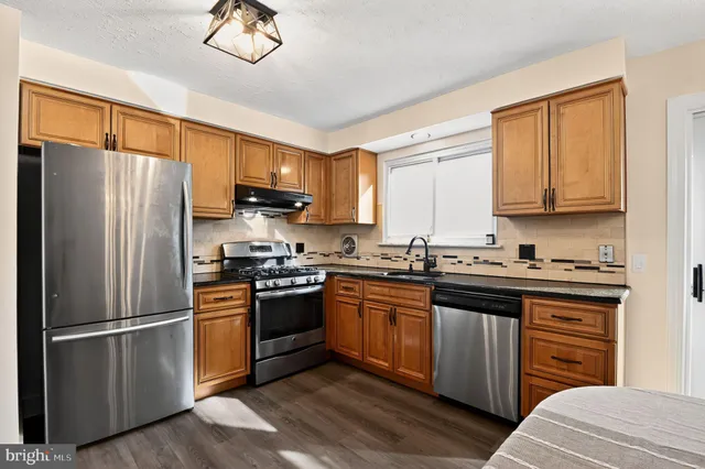 a bathroom with a sink a toilet a mirror and shower curtain