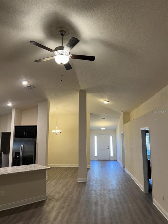 10 Diamond Ridge Way Ocala, FL 34472 - Photo 5 of 13 an empty room with wooden floor and a ceiling fan