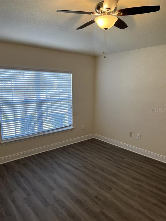 10 Diamond Ridge Way Ocala, FL 34472 - Photo 8 of 13 a view of an empty room with wooden floor and a window