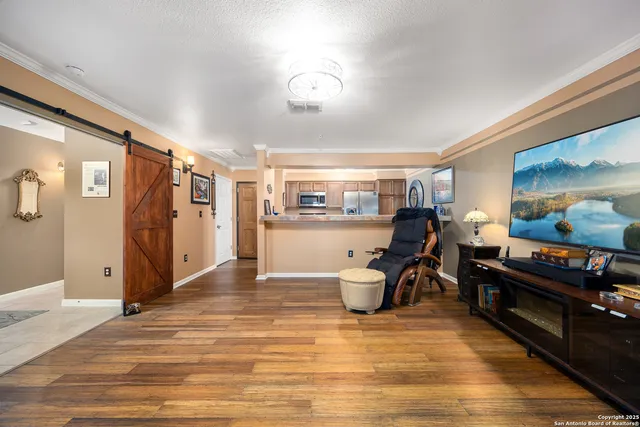a view of a workspace with furniture and wooden floor