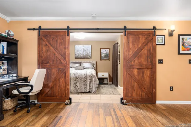a bed sitting in a bedroom next to a window