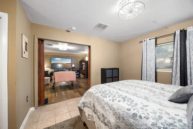 a bedroom with a large bed and a window