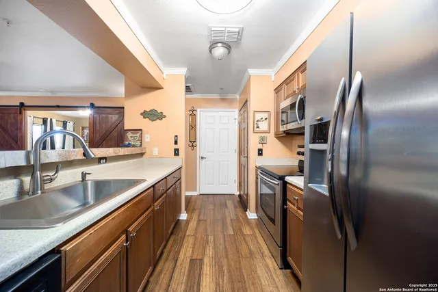 a kitchen with stainless steel appliances a stove a microwave and a refrigerator