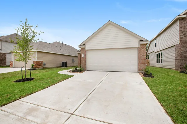 a front view of house with a yard and potted plants