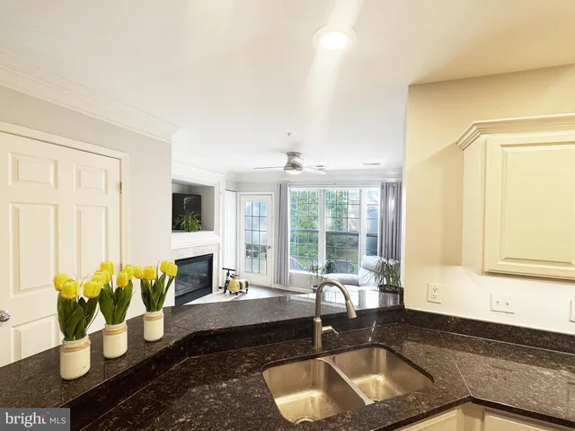a living room with furniture and floor to ceiling windows
