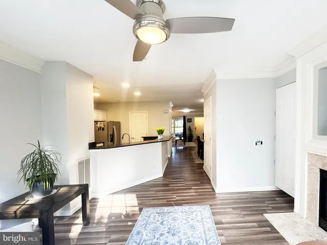a large living room with kitchen island furniture and a chandelier