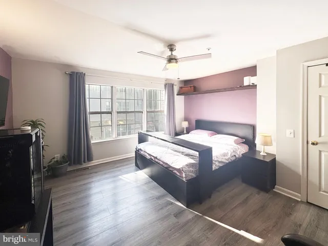 a spacious bedroom with a bed and a window