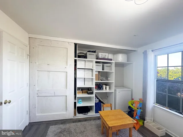 a room with a workspace and a window