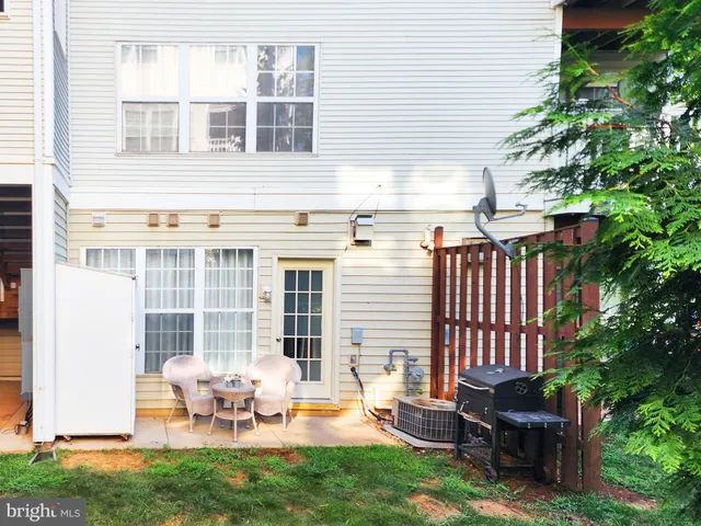 a backyard of a house with outdoor seating