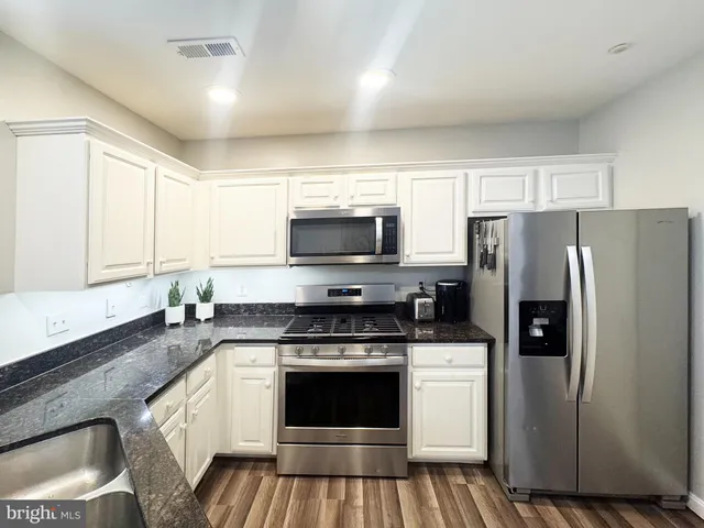 a kitchen with a stove microwave and refrigerator