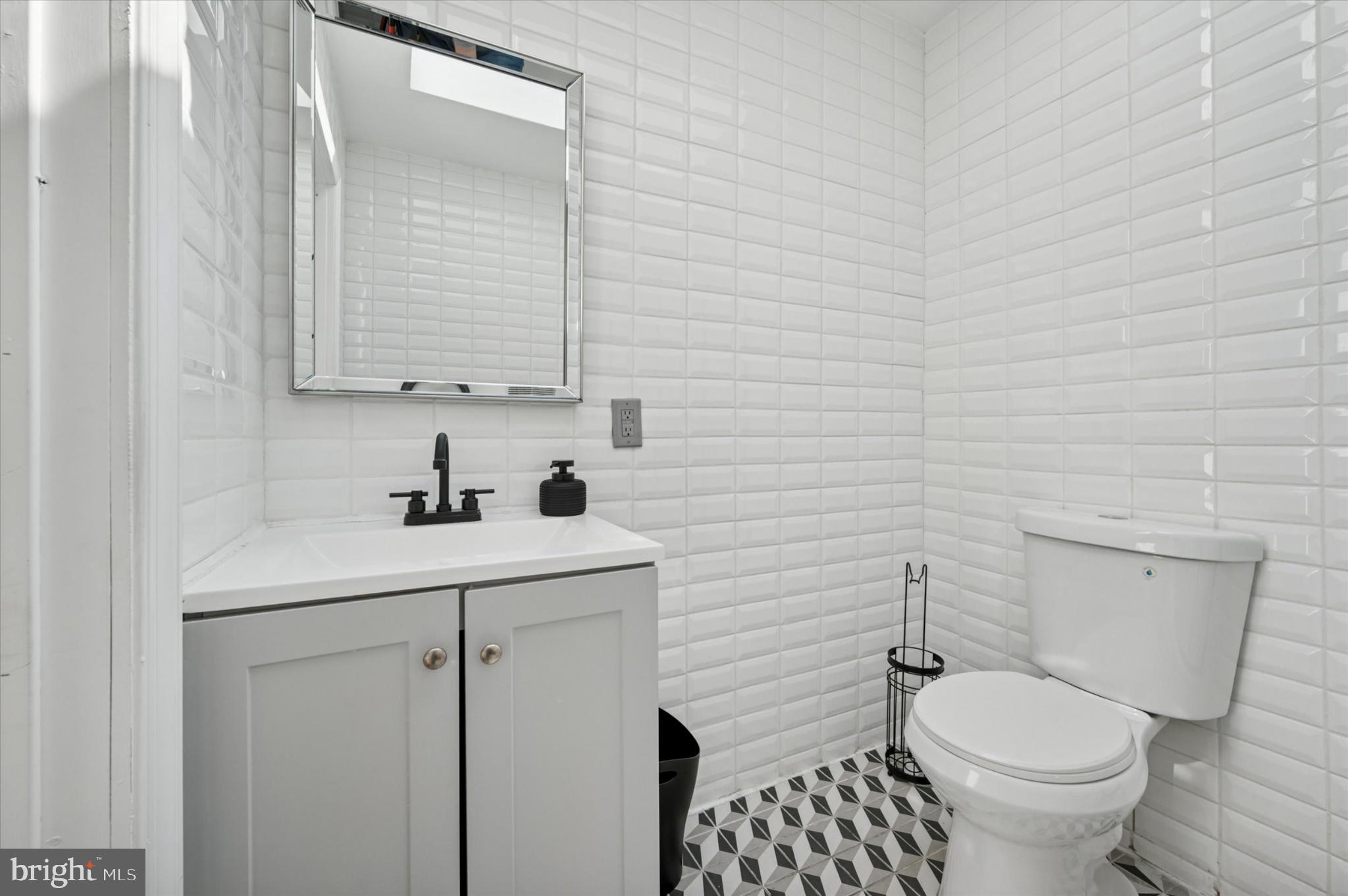 650 East Wensley Street Philadelphia, PA 19134 - Photo 17 of 24 a bathroom with a toilet a sink and mirror