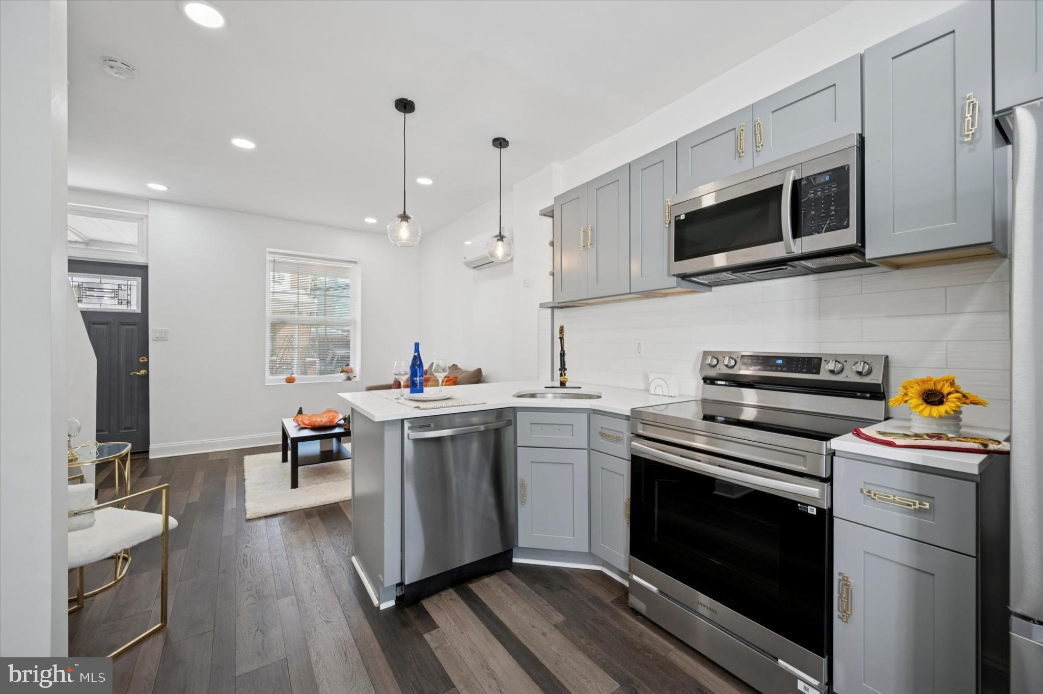 650 East Wensley Street Philadelphia, PA 19134 - Photo 8 of 24 a kitchen with stainless steel appliances a stove a sink and a microwave