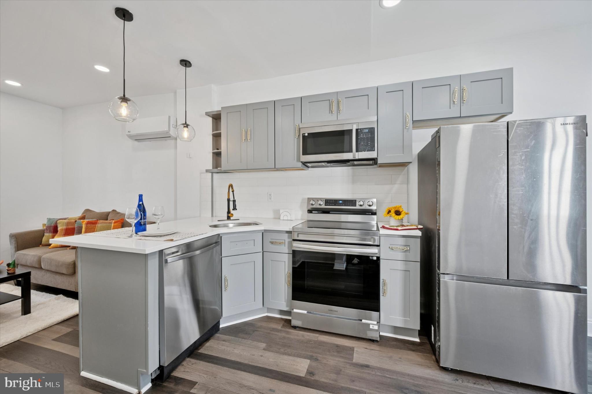 650 East Wensley Street Philadelphia, PA 19134 - Photo 9 of 24 a kitchen with kitchen island stainless steel appliances a stove a sink and a refrigerator