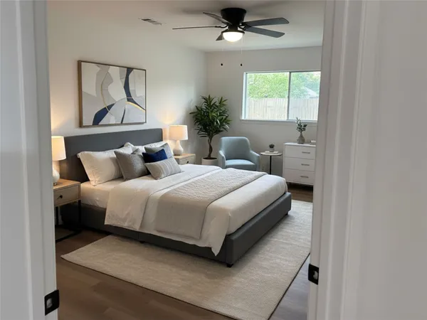 a bedroom with bed and a painting on the wall