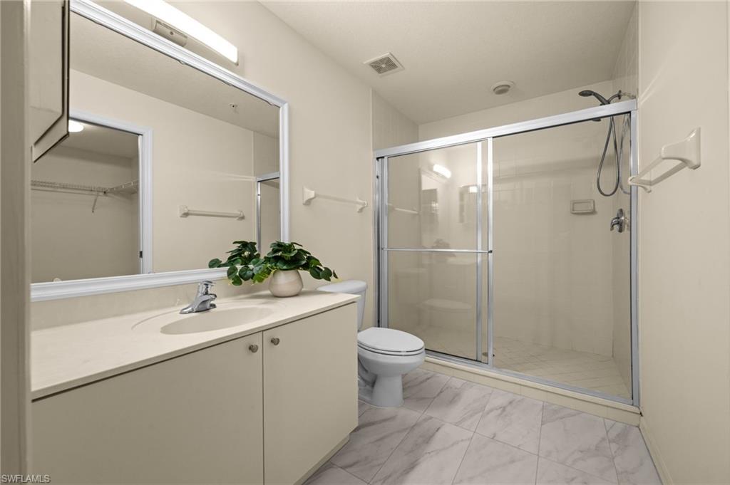 4520 Botanical Pl Circle, Unit 103 Naples, FL 34112 - Photo 11 of 19 Master bath & walk-in closet